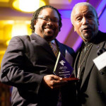 Chris B. Bennett, co-publisher of The Seattle Medium accepts the Municipal League of King County’s 2015 Community News Reporting Award from presenter Lacy Steele, president emeritus of the Seattle/King County NAACP.